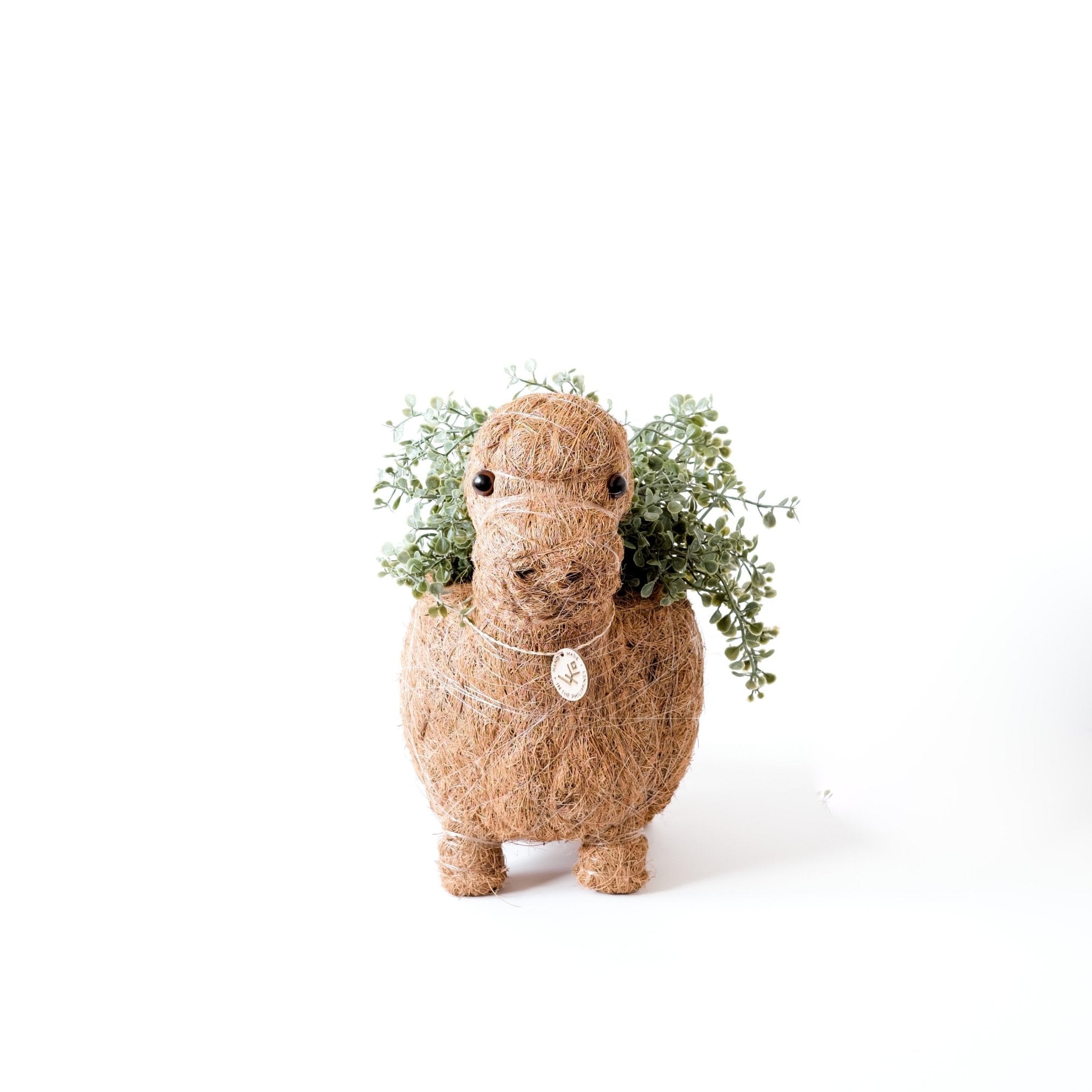 Coconut shell planter shaped like a horse with greenery on a white background