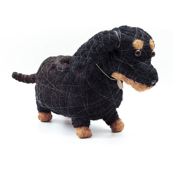 Black and brown dog-shaped toy made of string on a white background