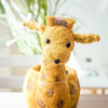Plush deer toy with a blurred indoor background
