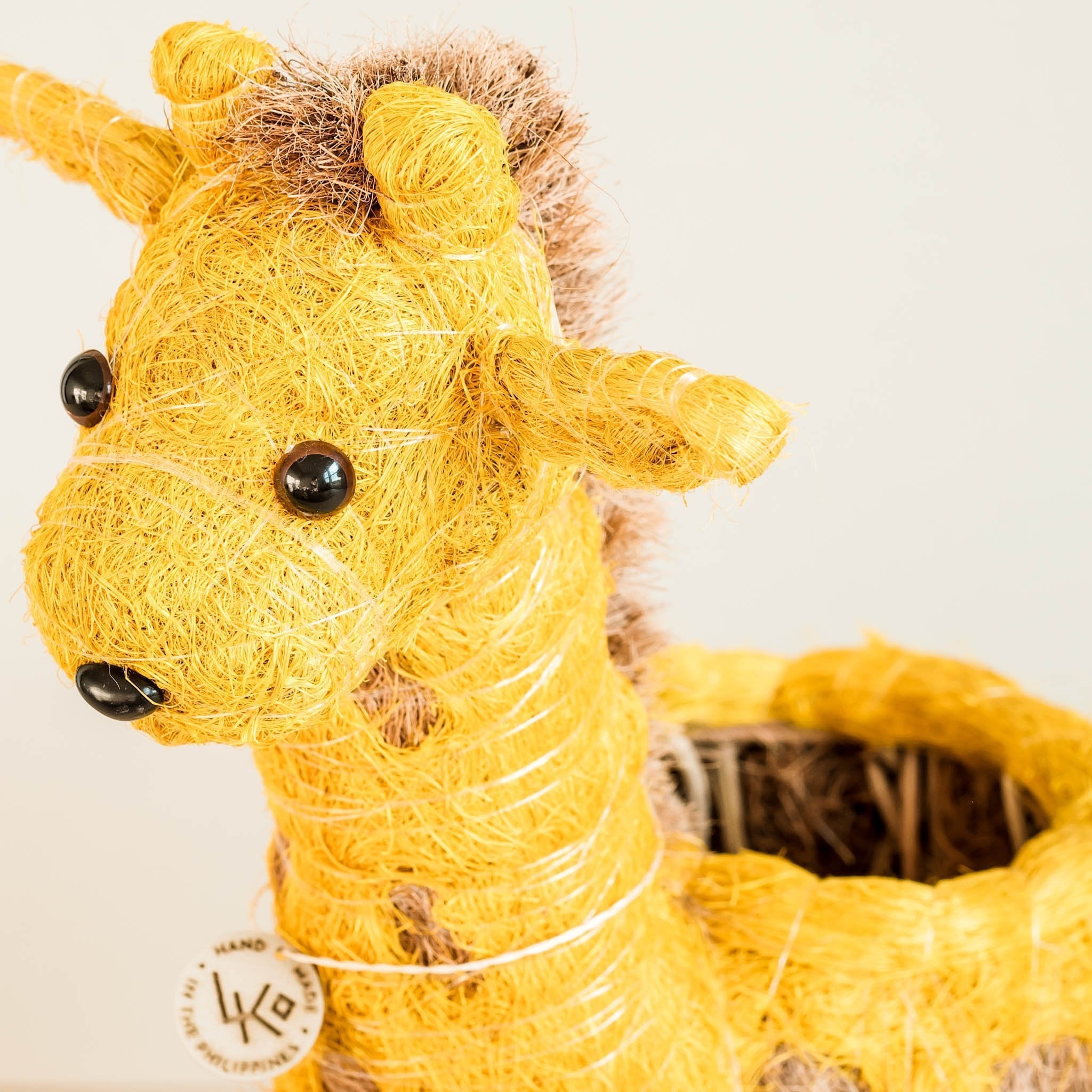 Yellow giraffe plush toy with a white background
