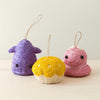 Three colorful felted animal ornaments on a light background