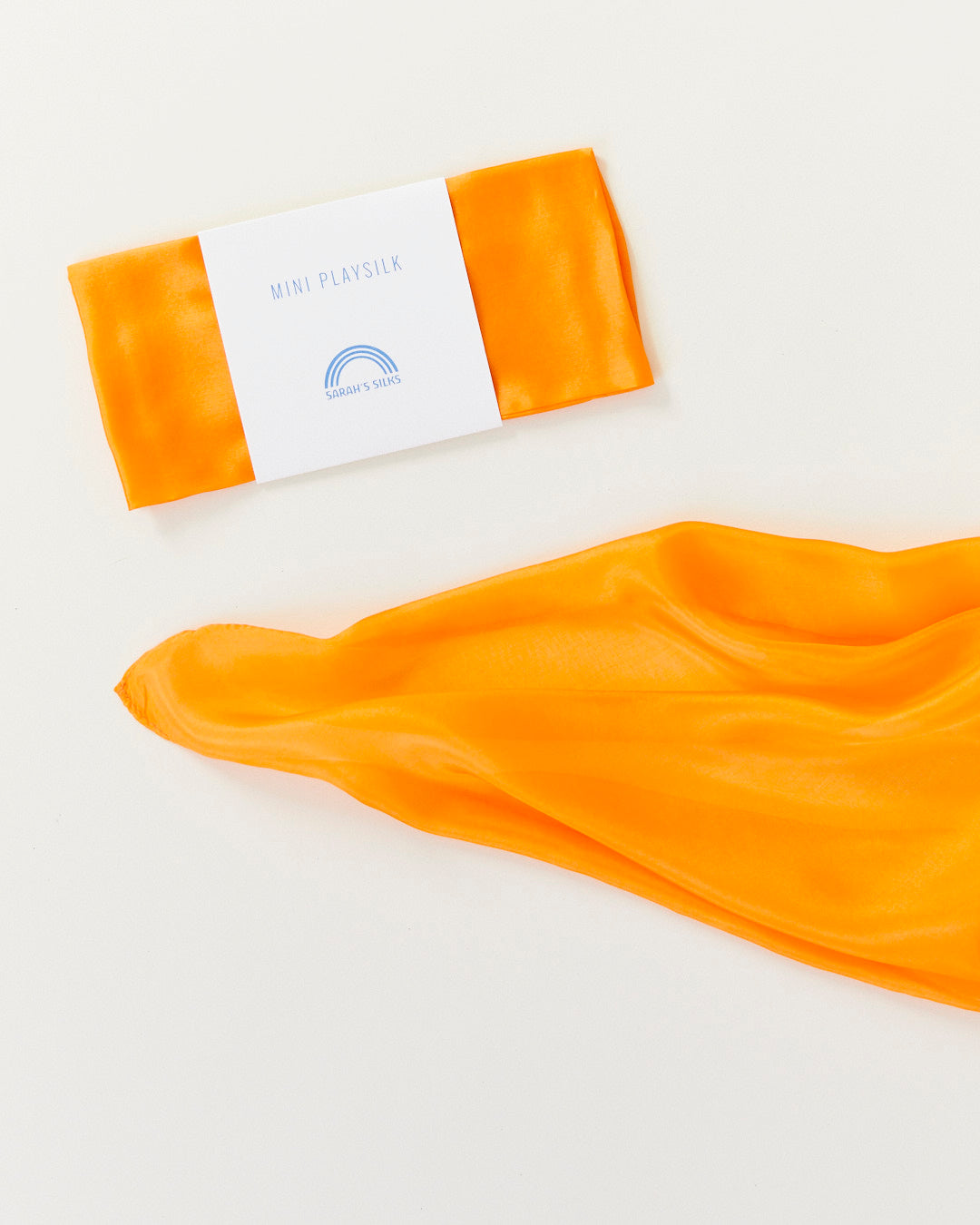 Orange fabric with a folded package on a white background