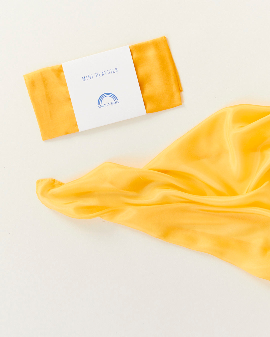 Yellow fabric with a folded package on a white background