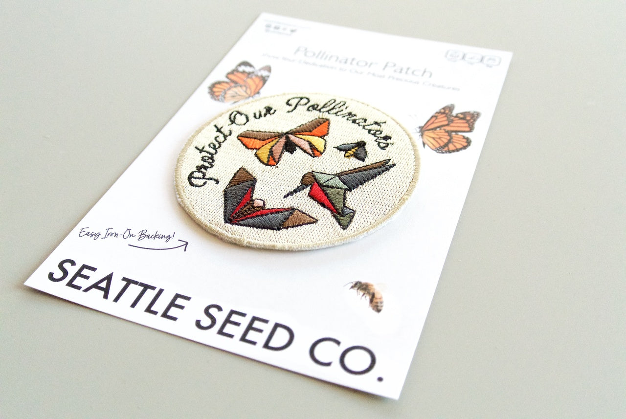 Close-up of pollinator-themed embroidered patch with iron-on backing, 3-inch size