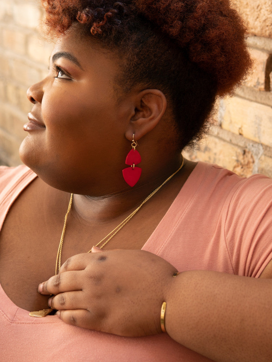 Side view of Fair Anita Modern Poppy Dangle Earrings showing 2.5 inch length and bold red colour