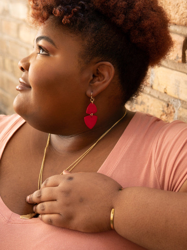 Side view of Fair Anita Modern Poppy Dangle Earrings showing 2.5 inch length and bold red colour