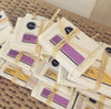 Shea butter olive oil soap bars with Heliconia branding on a woven surface.
