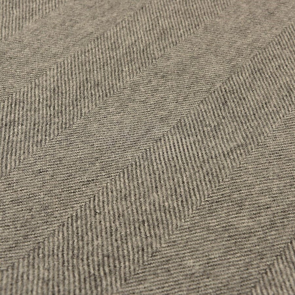Close-up of a textured gray fabric with a subtle pattern