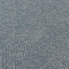 Close-up of blue denim fabric with a herringbone pattern
