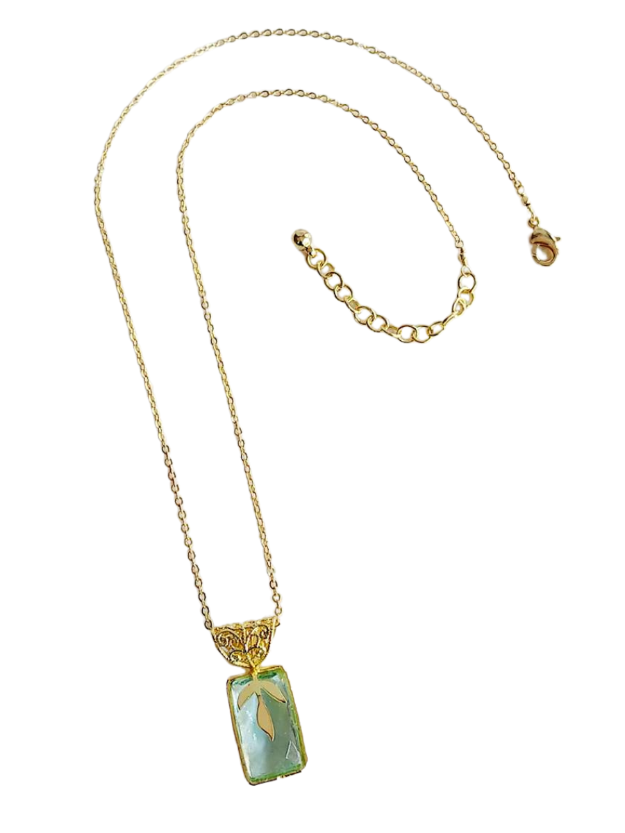 Close-up of Promenade glass bead pendant necklace showing gold-plated recycled brass chain and 1 inch pendant detail