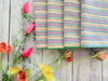 Rainbow seersucker cloth napkins folded and styled on a table, set of four