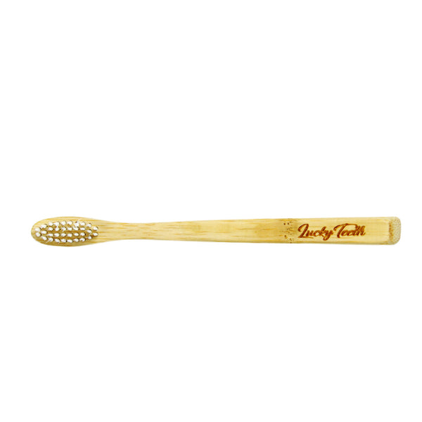 Bamboo toothbrush with 'Lucky Tooth' branding on a white background