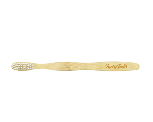 Bamboo toothbrush with 'Lucky Tooth' branding on a white background