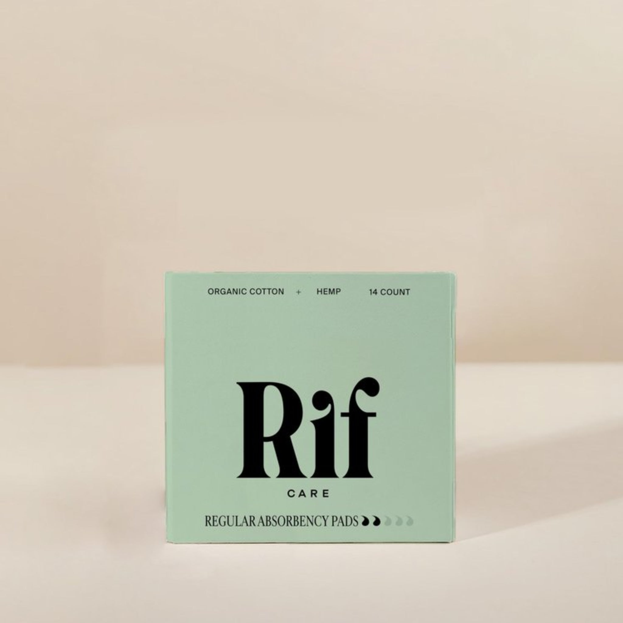 Box of Rif Care regular absorbency pads on a beige background