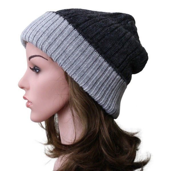 Mannequin head wearing a black and gray striped beanie on a white background