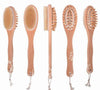 Set of five wooden brushes with bristle heads on a white background