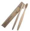 Two bamboo toothbrushes with a cardboard packaging on a white background