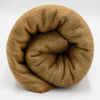 Coiled brown yarn on a white background