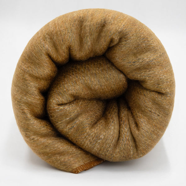 Coiled brown yarn on a white background