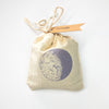 Close-up of an organic linen lavender sachet with dried lavender buds, eco-friendly home freshener