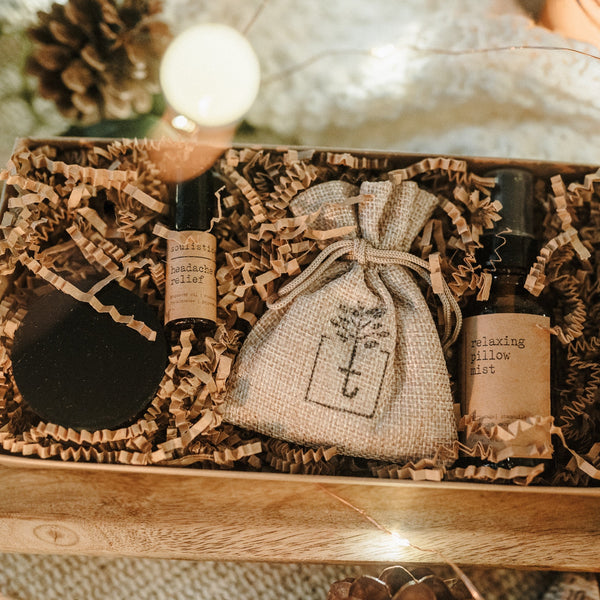 Gift set with bottles and a pouch on a wooden surface