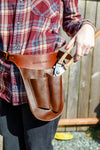 Seattle Seed Company leather gardener's tool belt worn in garden setting with tools organised in pockets