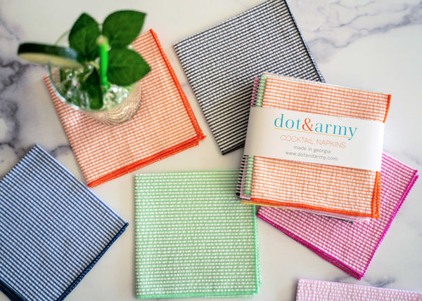 Set of four seersucker cloth cocktail napkins in mixed colours by Dot and Army, laid out on a flat surface