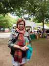 Person wearing the Ganapati Meditation Shawl as a wrap, showcasing the terracotta colour and traditional Ganesha print by OMSutra