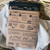 Sheet Happens dissolvable laundry sheets shown next to washing machine – works in HE and top-load washers