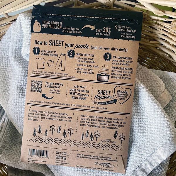 Sheet Happens dissolvable laundry sheets shown next to washing machine – works in HE and top-load washers