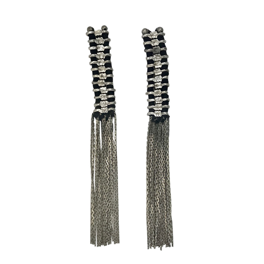 Pair of long tassel earrings with black and silver design on a white background