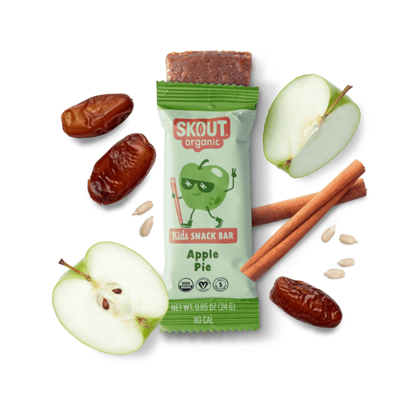 Skout organic kids snack bar with apples, dates, and cinnamon on a dark background
