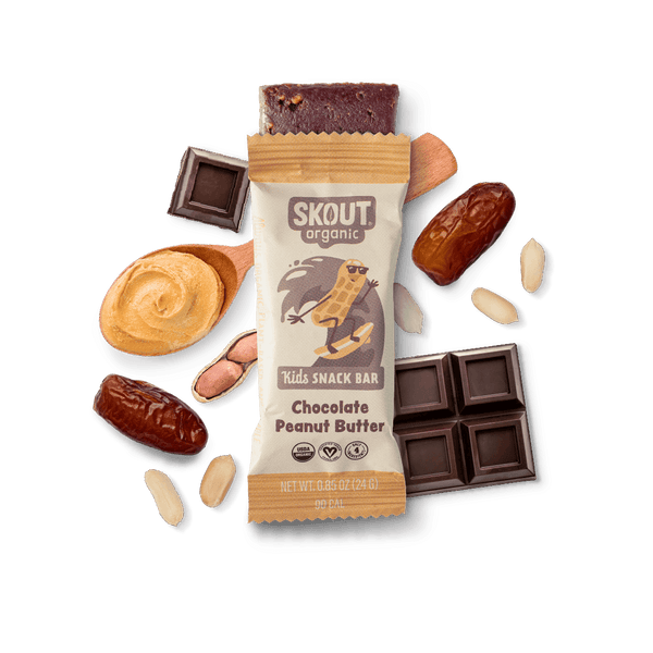 Skout Organic Kids Snack Bar with chocolate and peanut butter, surrounded by ingredients on a dark background