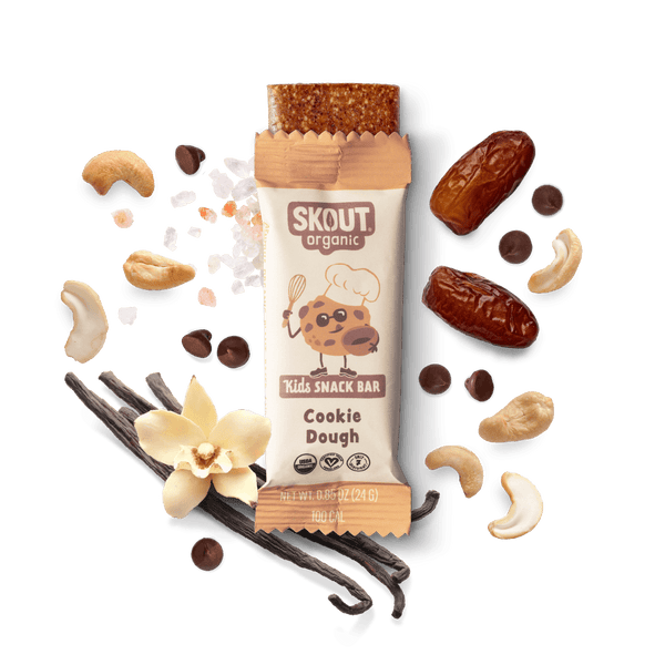Skout Organic Kids Snack Bar with cookie dough flavor surrounded by ingredients on a dark background