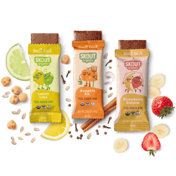 Three Skout organic snack bars with lemon, pumpkin pie, and strawberry banana flavors on a dark background.