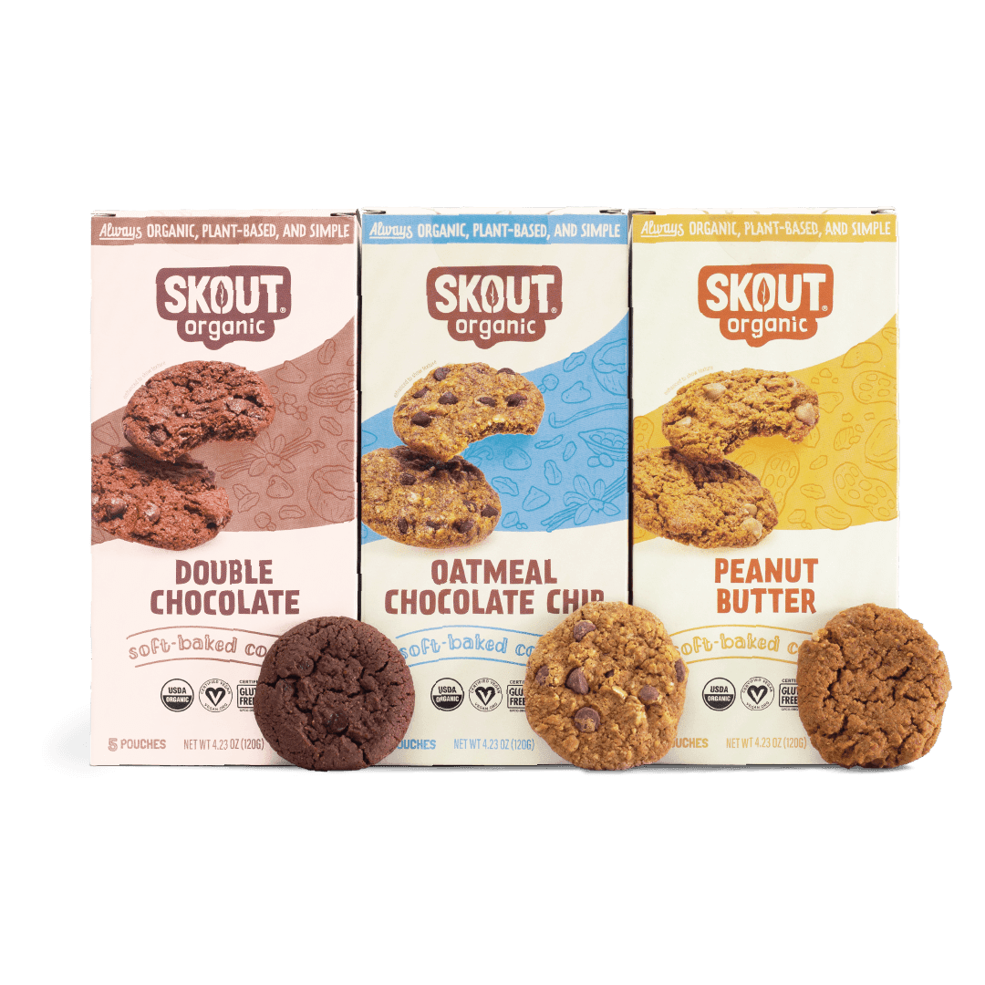 Three boxes of Skout Organic cookies on a green background