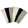Set of four folded knitted arm warmers in black, beige, and gray on a white background. Shop the Snow Essential Knit Alpaca Gloves at Clozist. Handcrafted in Peru from eco-friendly Baby Alpaca fiber, these luxury fingerless gloves combine royal softness with modern functionality. The perfect sustainable gift for warmth and style. Shop the green Amazon alternative!