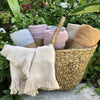 Woven basket with colorful scarves in a garden setting