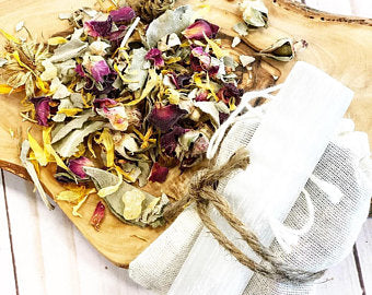 Organic smudge set with white sage blend, frankincense resin, rose petals, charcoal disk, and raw selenite wand in an unbleached muslin bag by Butter Me Up Organics