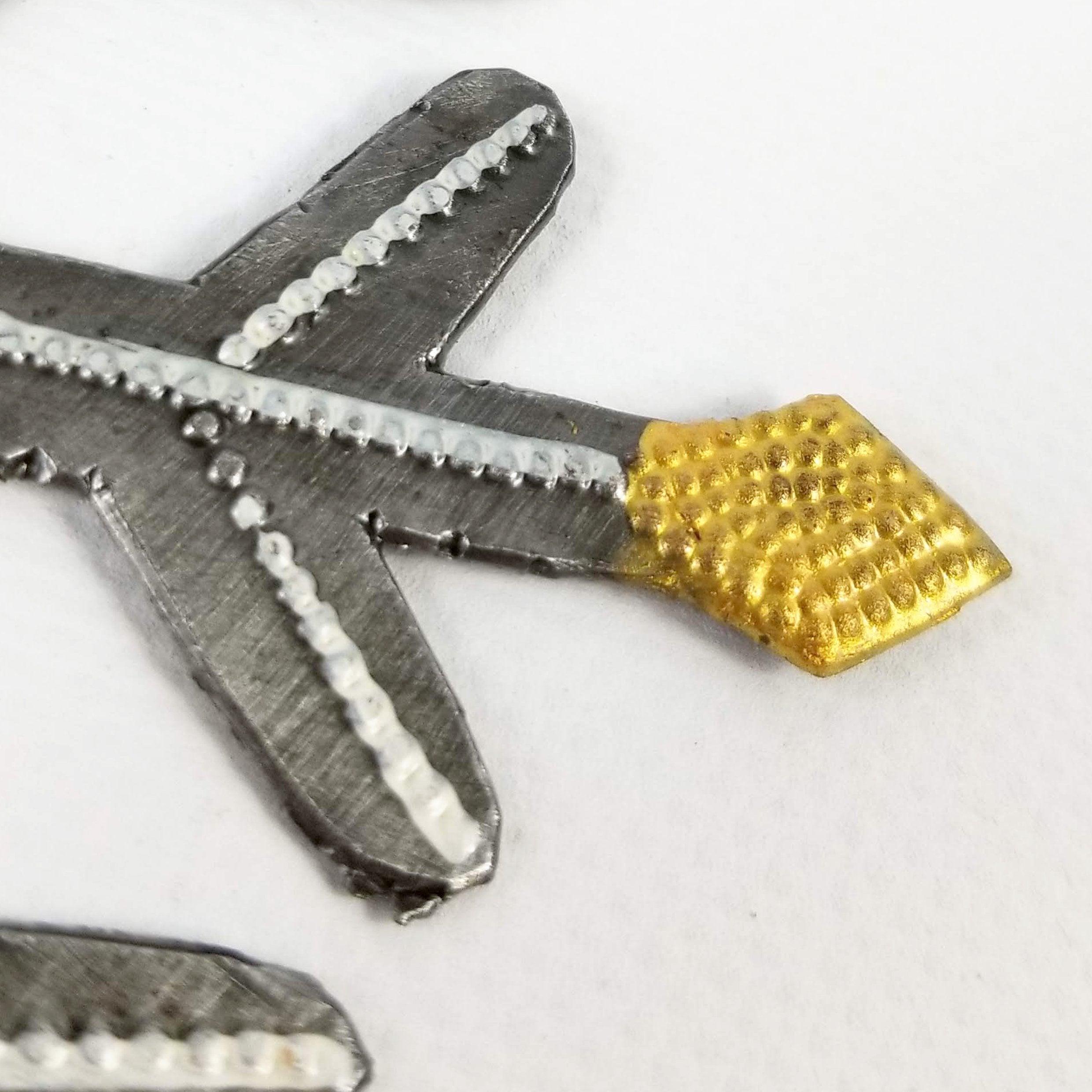 Metallic tool with a gold handle on a white background