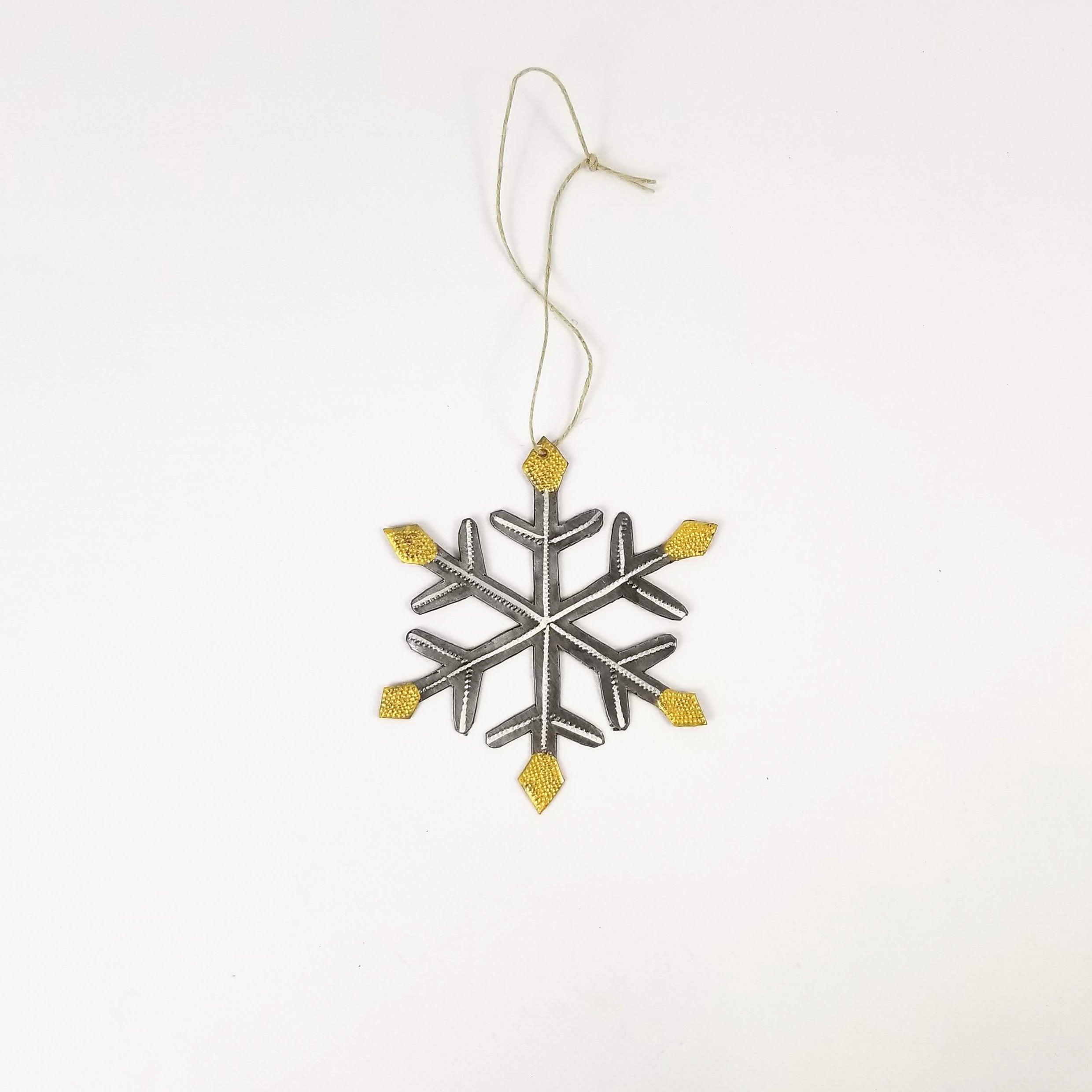 Decorative snowflake ornament with gold accents on a white background