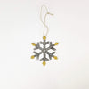 Decorative snowflake ornament with gold accents on a white background