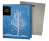 A blue folding greeting card with a white tree and red bird design, and the text 'Give Thanks' on the front.