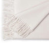 White blanket with fringe on a white background