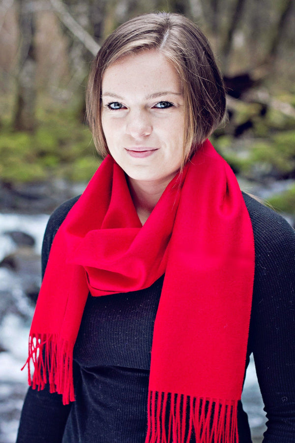 Woman wearing a red scarf with a blurred natural background