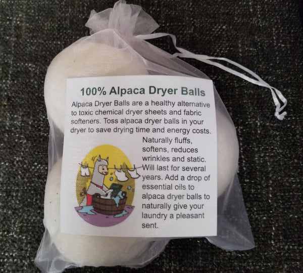 Alpaca dryer balls in a clear bag with a label on a dark textured background