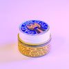Makeup removal pad with colorful packaging on a light purple background