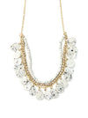 Speckled bone necklace with white upcycled bone details and brass beaded chain on a flat lay background