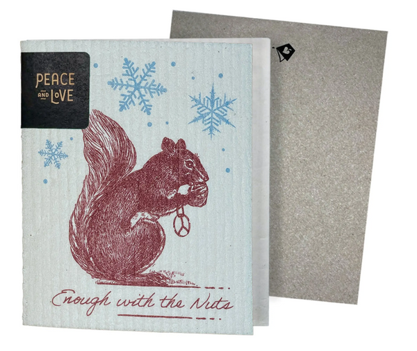 A greeting card with a vintage etching of a squirrel holding a snowflake, with ' Enough with the Nuts ' text, against a blue background. A non-velop envelope is shown to the side.