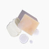 Detailed texture shot of Heliotrope massage candle and soap included in the Discovery Kit